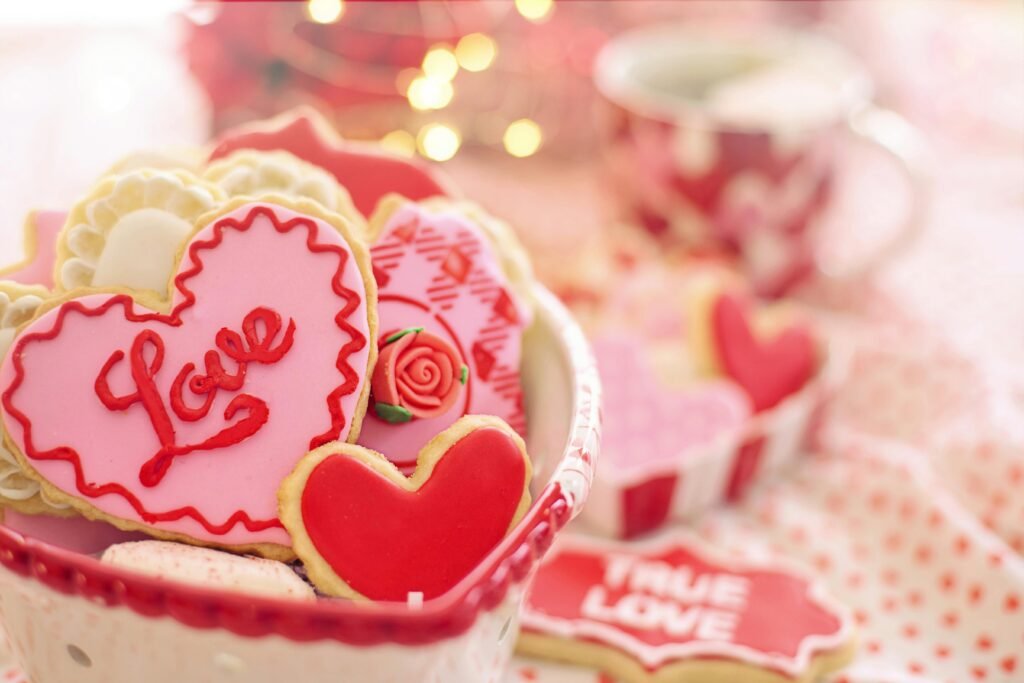 Heart-shaped cookies with 'Love' icing in a romantic setting, perfect for Valentine's Day.